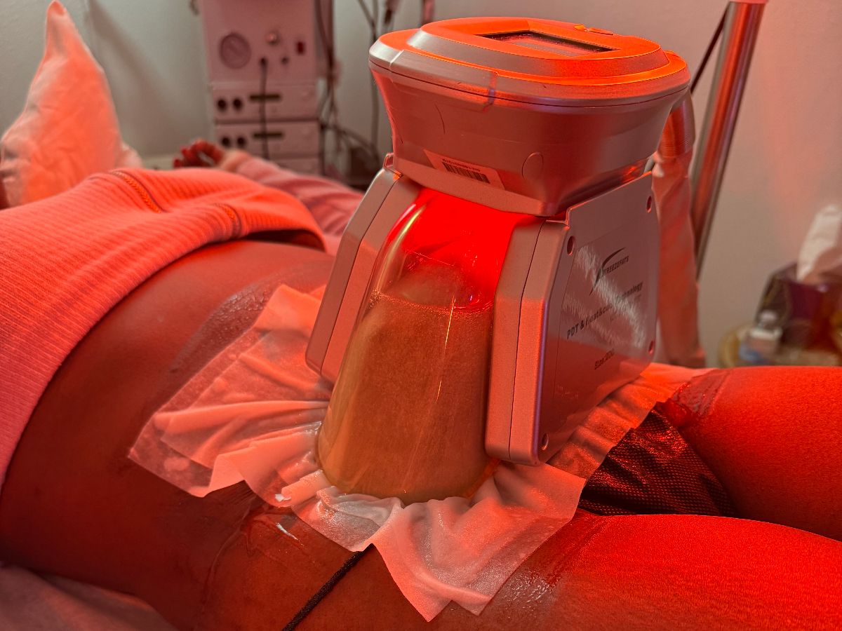 A client undergoes a cryolipolysis fat freeze treatment at Namaste Skincare & Wellness in Henderson, with a specialized device targeting the midsection. This non-invasive spa service add-on is designed to reduce stubborn fat through controlled cooling.