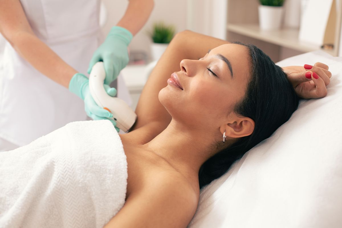 Woman relaxing during laser skin rejuvenation treatment.